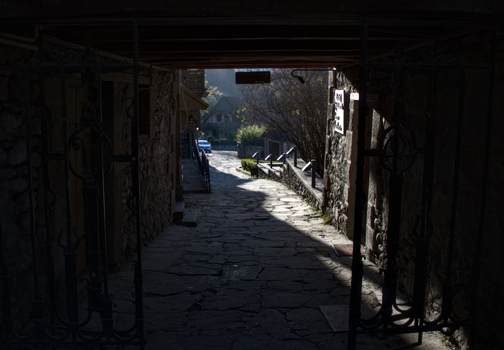 a dark alley with a car parked on the side of it