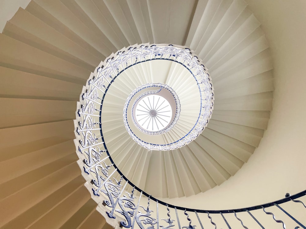 a spiral staircase in a building with a skylight