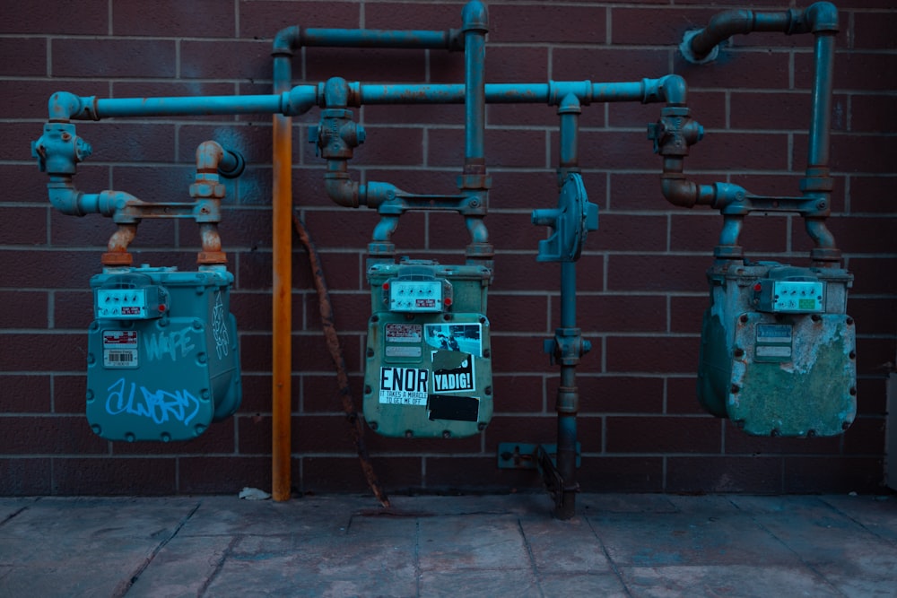 a brick wall with a bunch of pipes attached to it