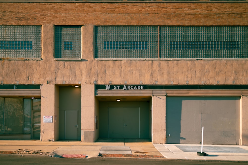 a building with two garages and a street sign in front of it