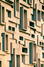 a building made of blocks with a clock on the front of it