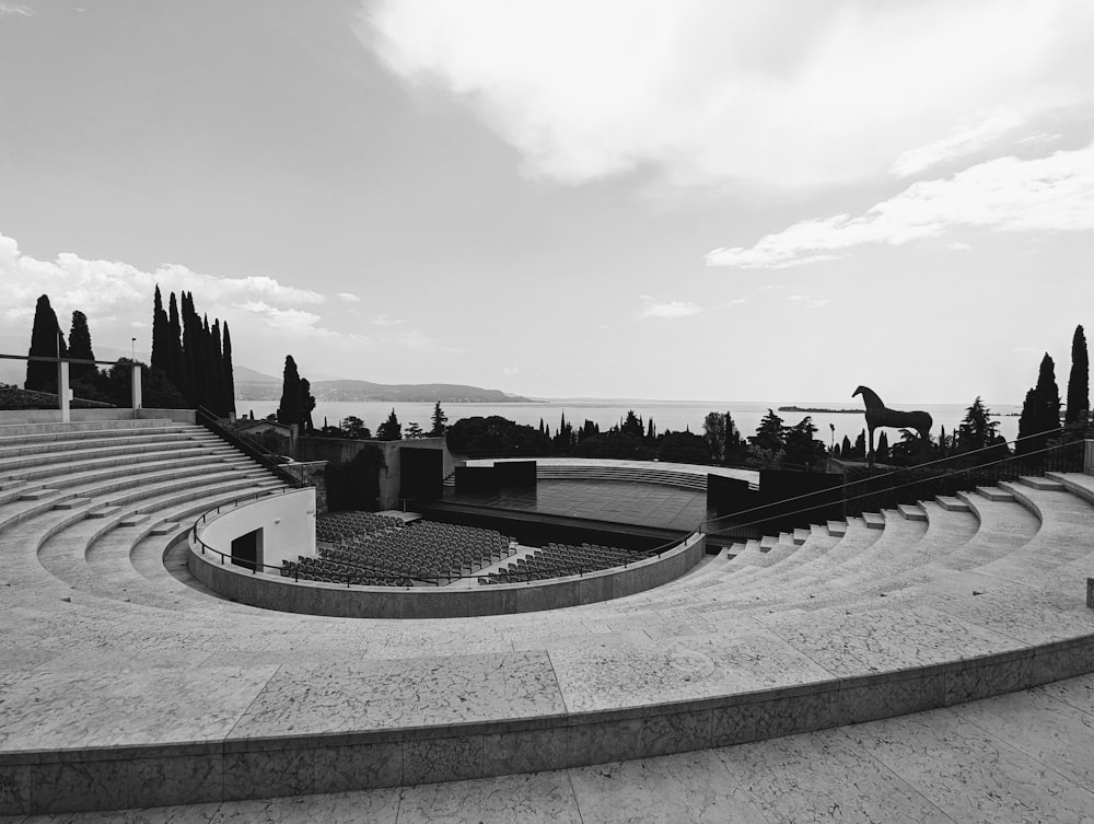 a black and white photo of a stage with a view of the ocean