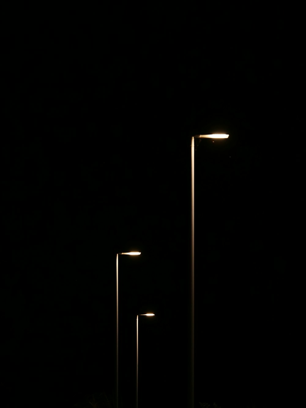 a row of street lights sitting next to each other