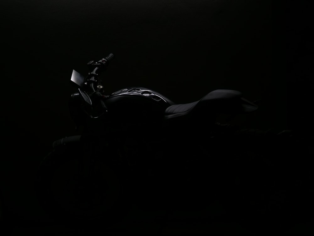 a motorcycle is shown in the dark with its headlights on
