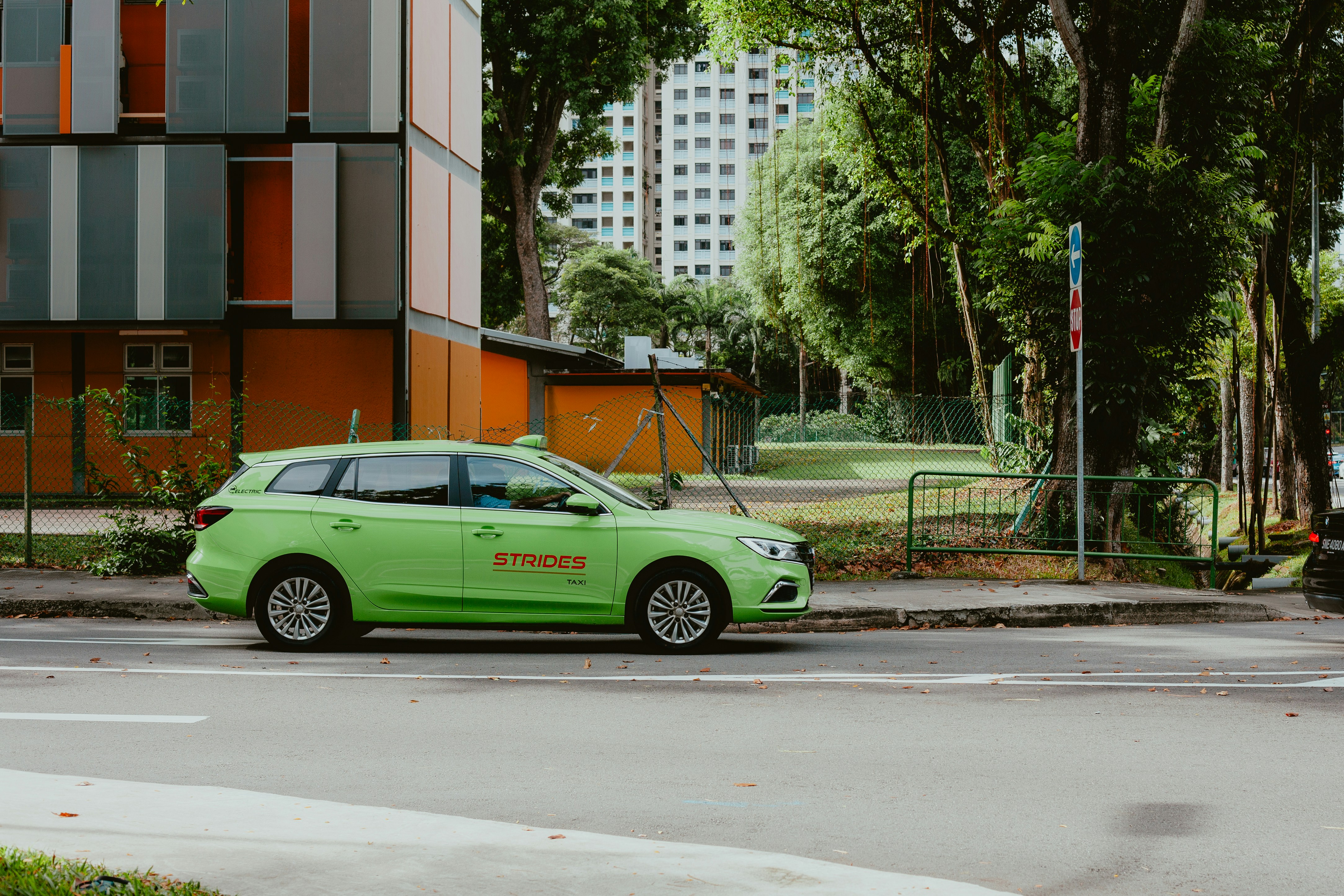 Compact sedan driving through a city, representing an affordable daily driver