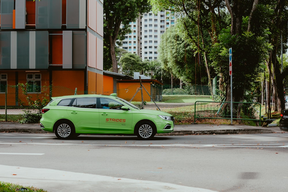 a green car parked on the side of the road