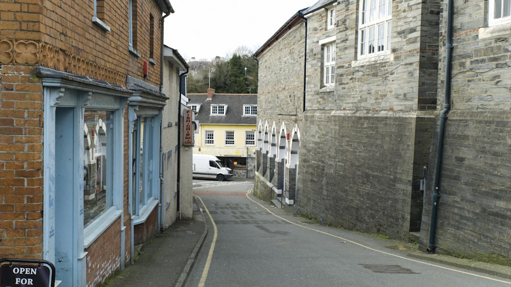 a narrow street lined with brick buildings next to a street sign