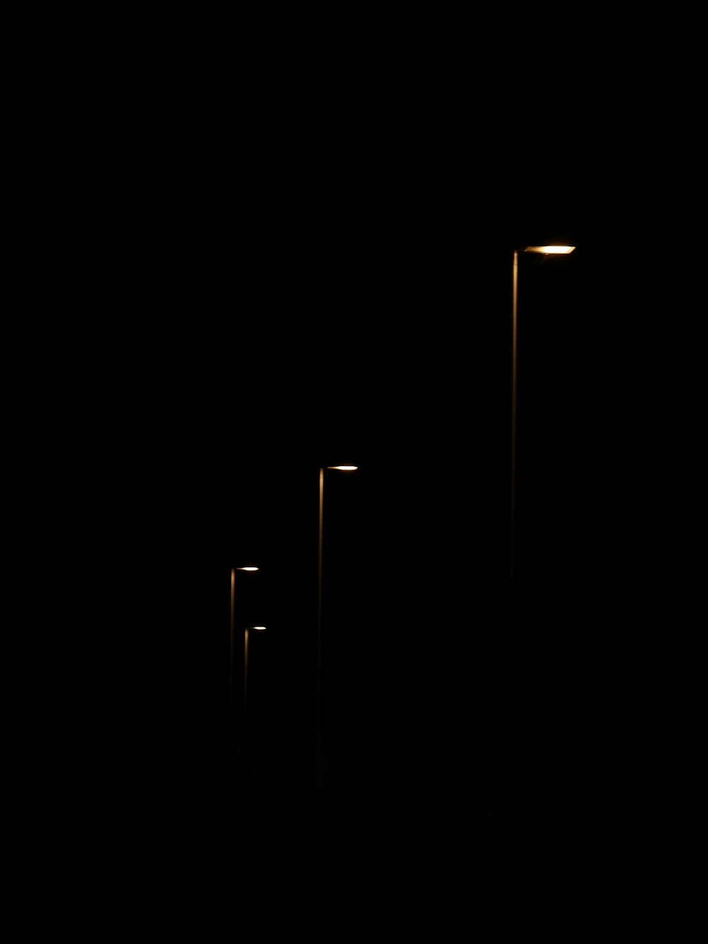 a row of street lights in the dark