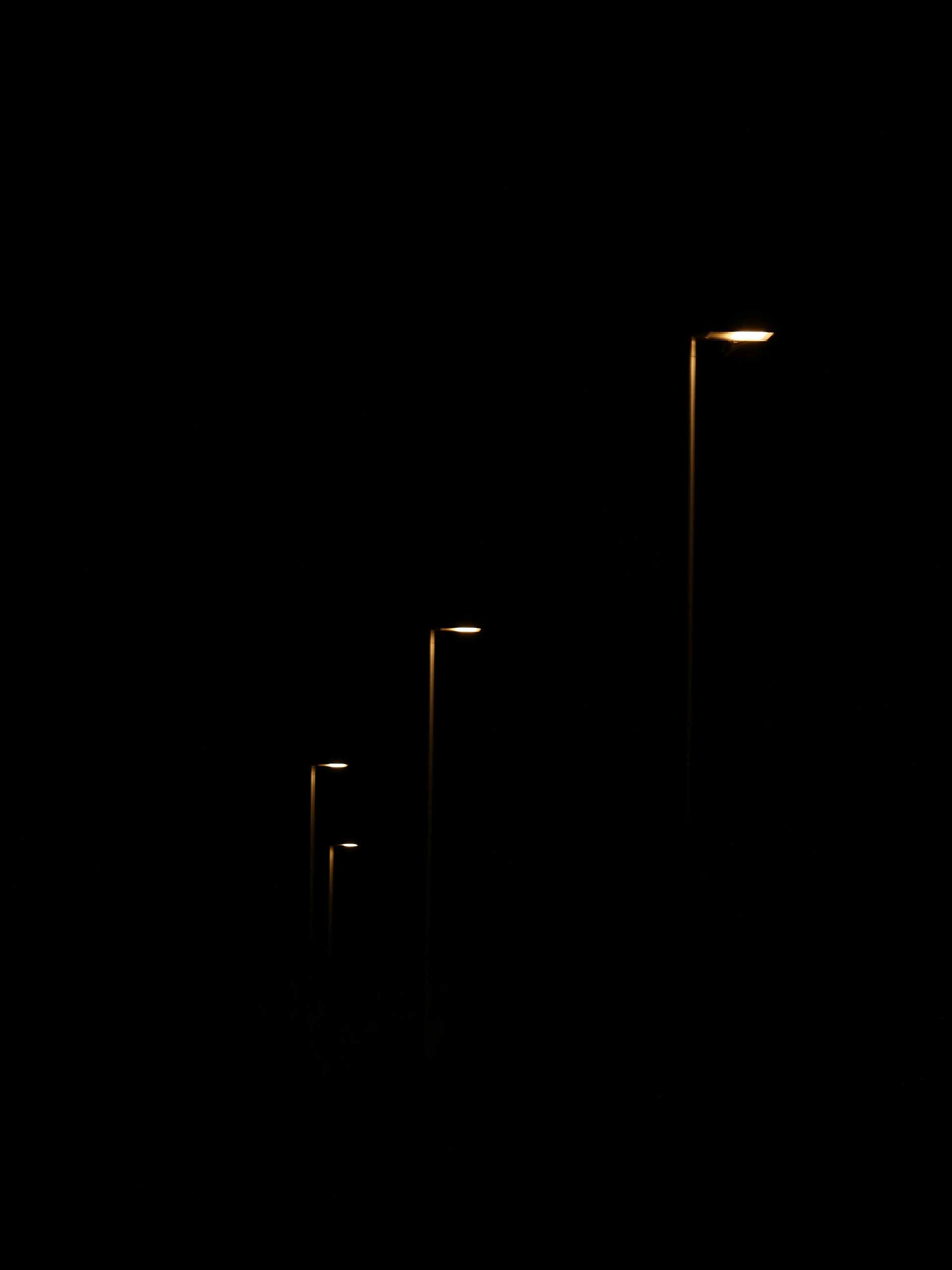 a row of street lights in the dark