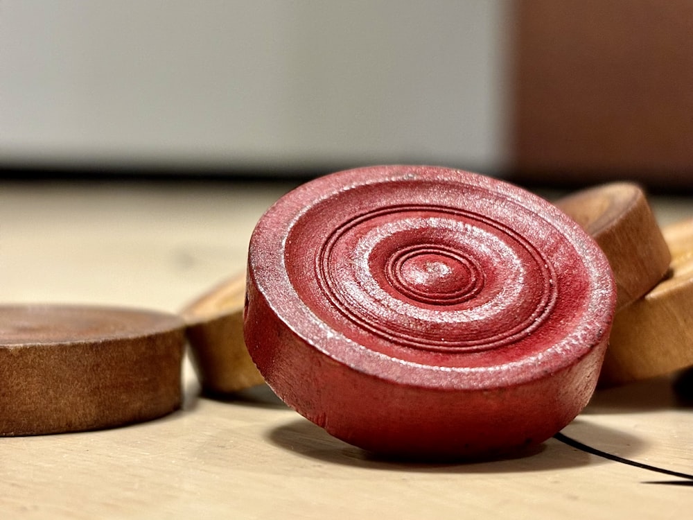 a red object sitting on top of a wooden table