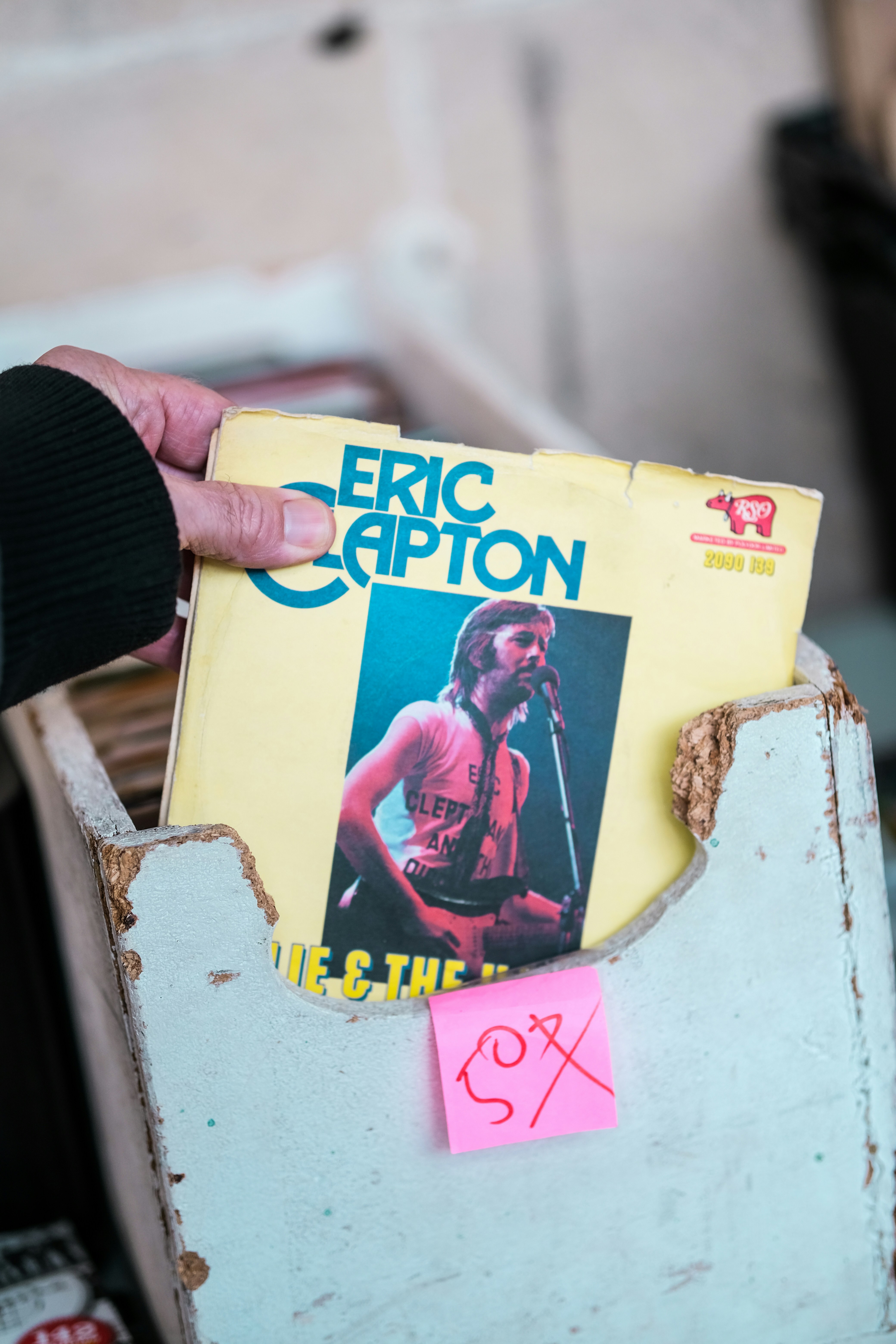 a person holding a record in their left hand
