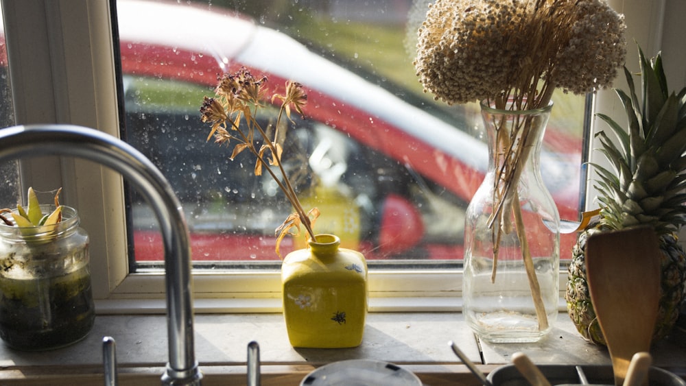 a window sill with a vase of flowers in it