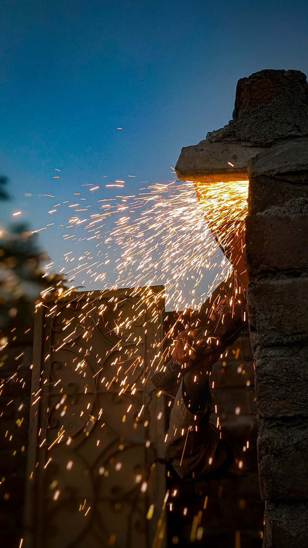 a person is using a grinder to grind a piece of metal