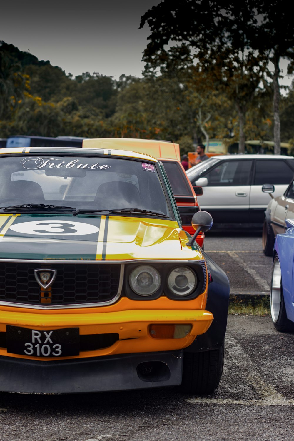 a group of cars parked next to each other in a parking lot