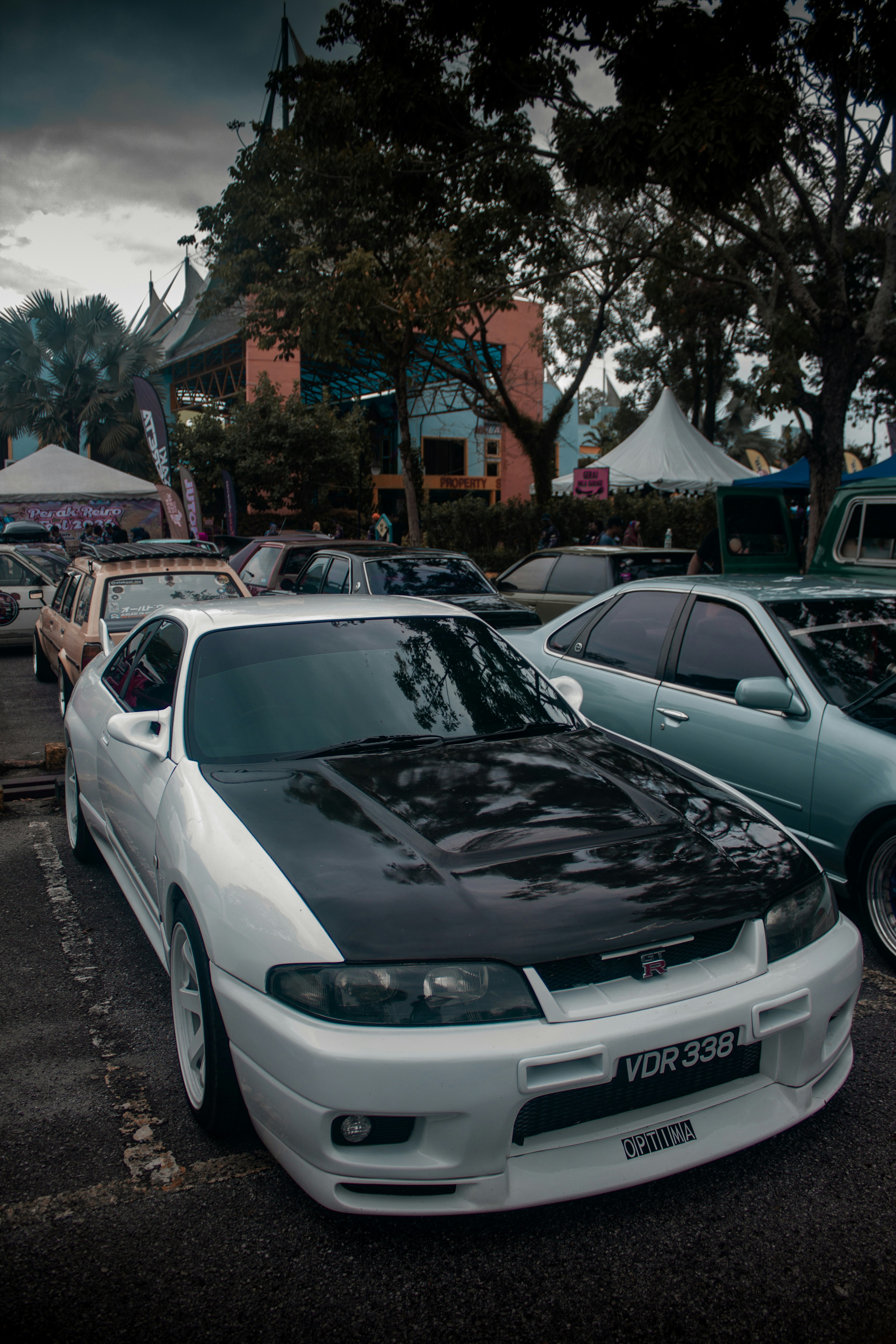 a group of cars parked next to each other in a parking lot