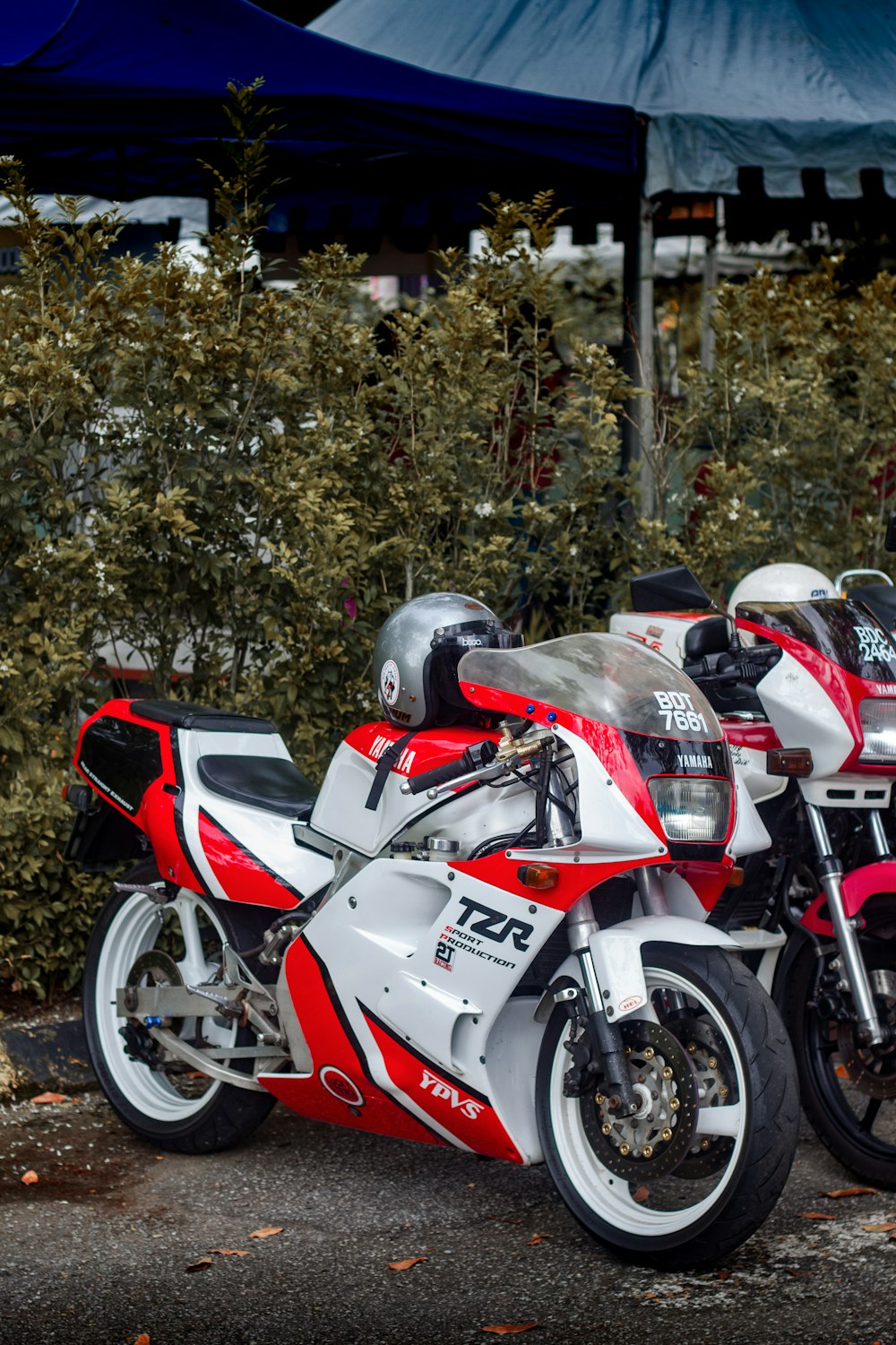 two red and white motorcycles parked next to each other