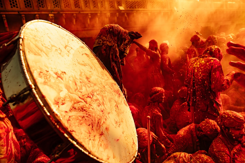 a large group of people covered in red paint