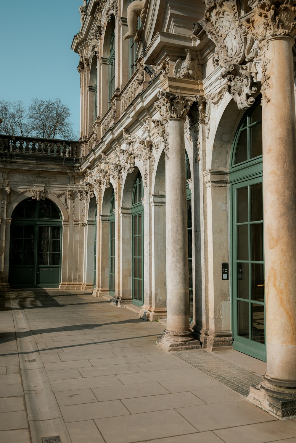 a building with columns and a clock on the front of it