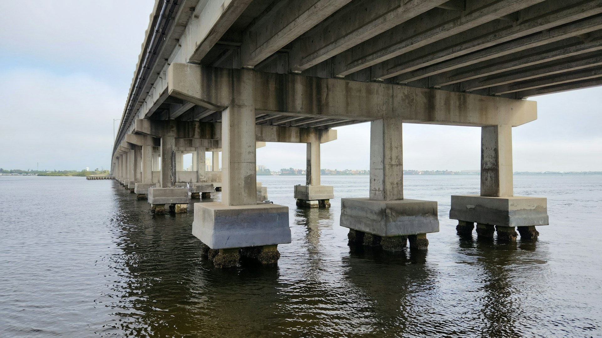 the underside of a bridge over a body of water
