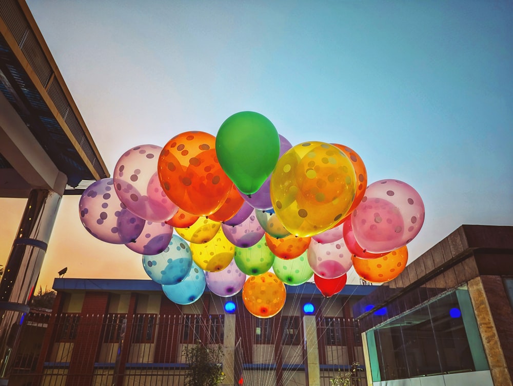 a bunch of balloons floating in the air