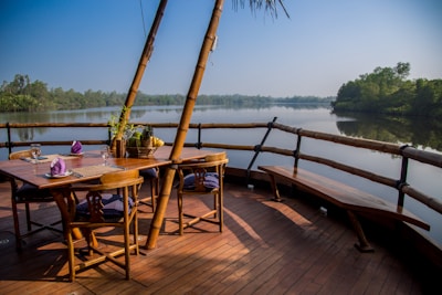 a wooden deck with a table and chairs on it