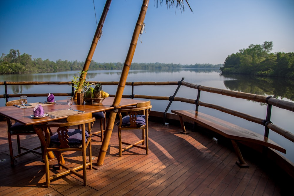 a wooden deck with a table and chairs on it