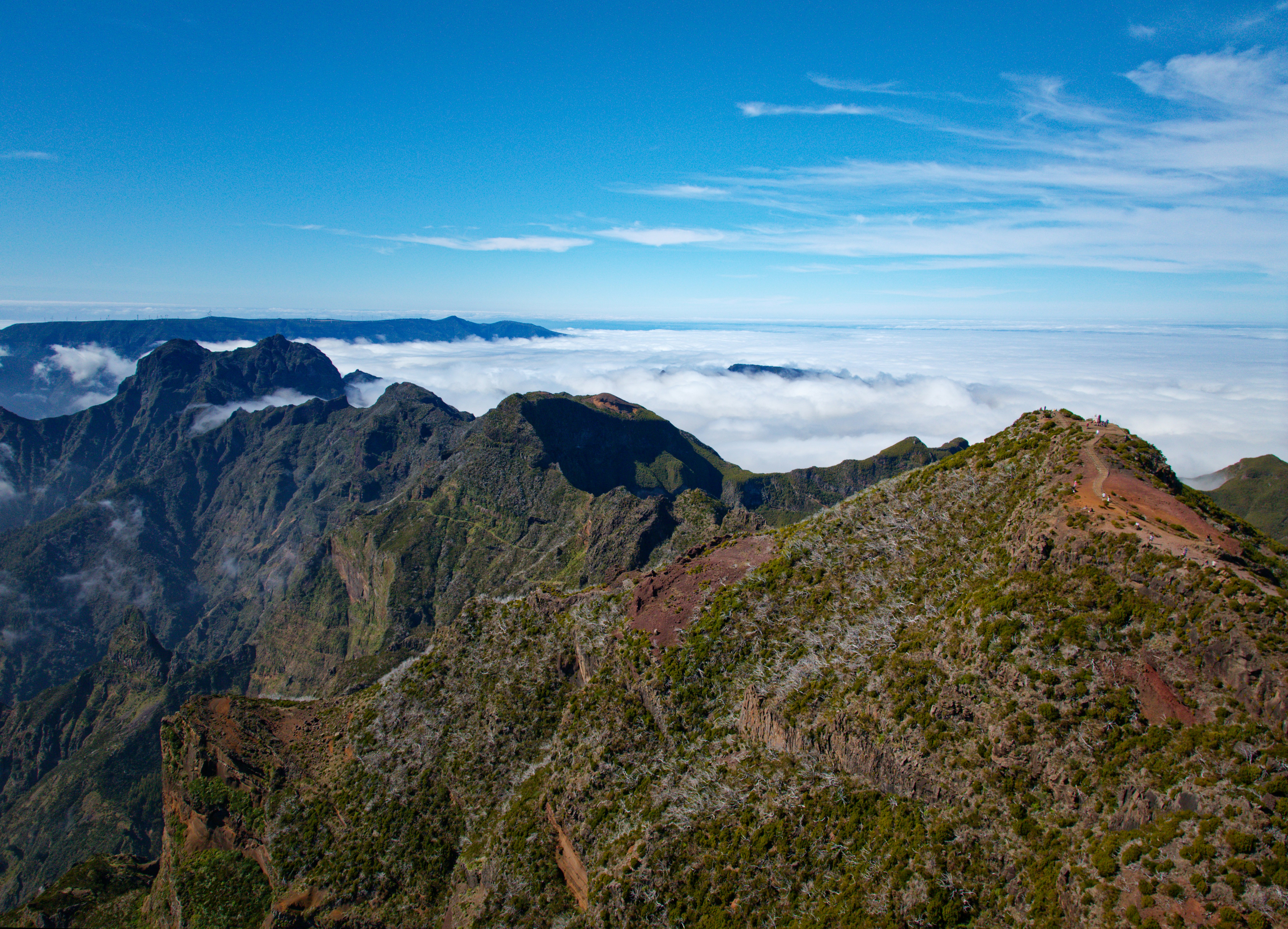 a view of the top of a mountain in the clouds, Image of the 1,800 M volcanic peak of Pico Ruivo in the mountains of Madeira.
