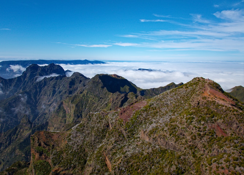 a view of the top of a mountain in the clouds