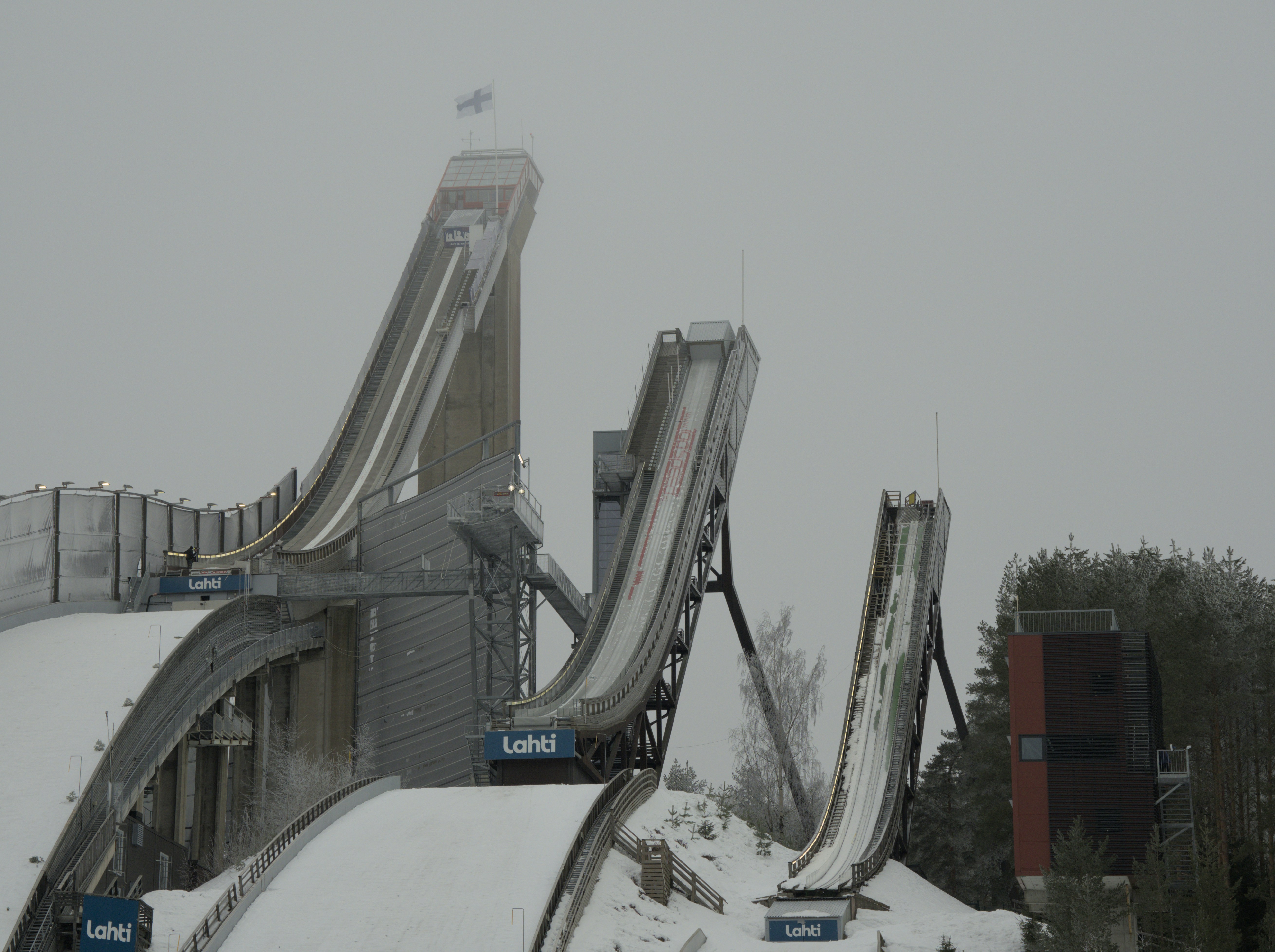 a snow covered hill with a slide going down it