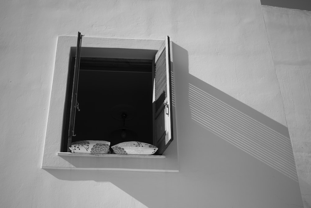 a black and white photo of a small window