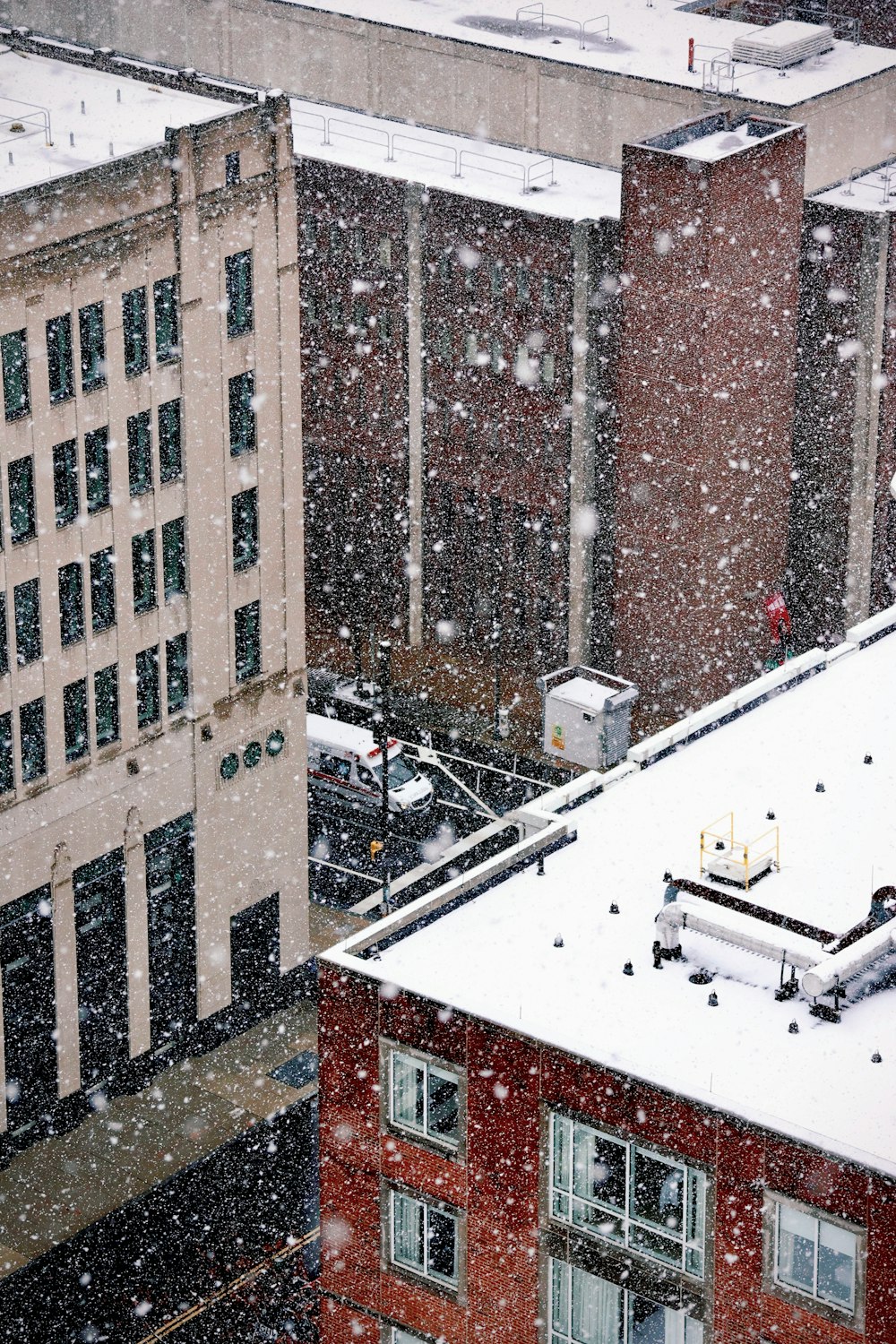 a snowy day in a city with a few buildings