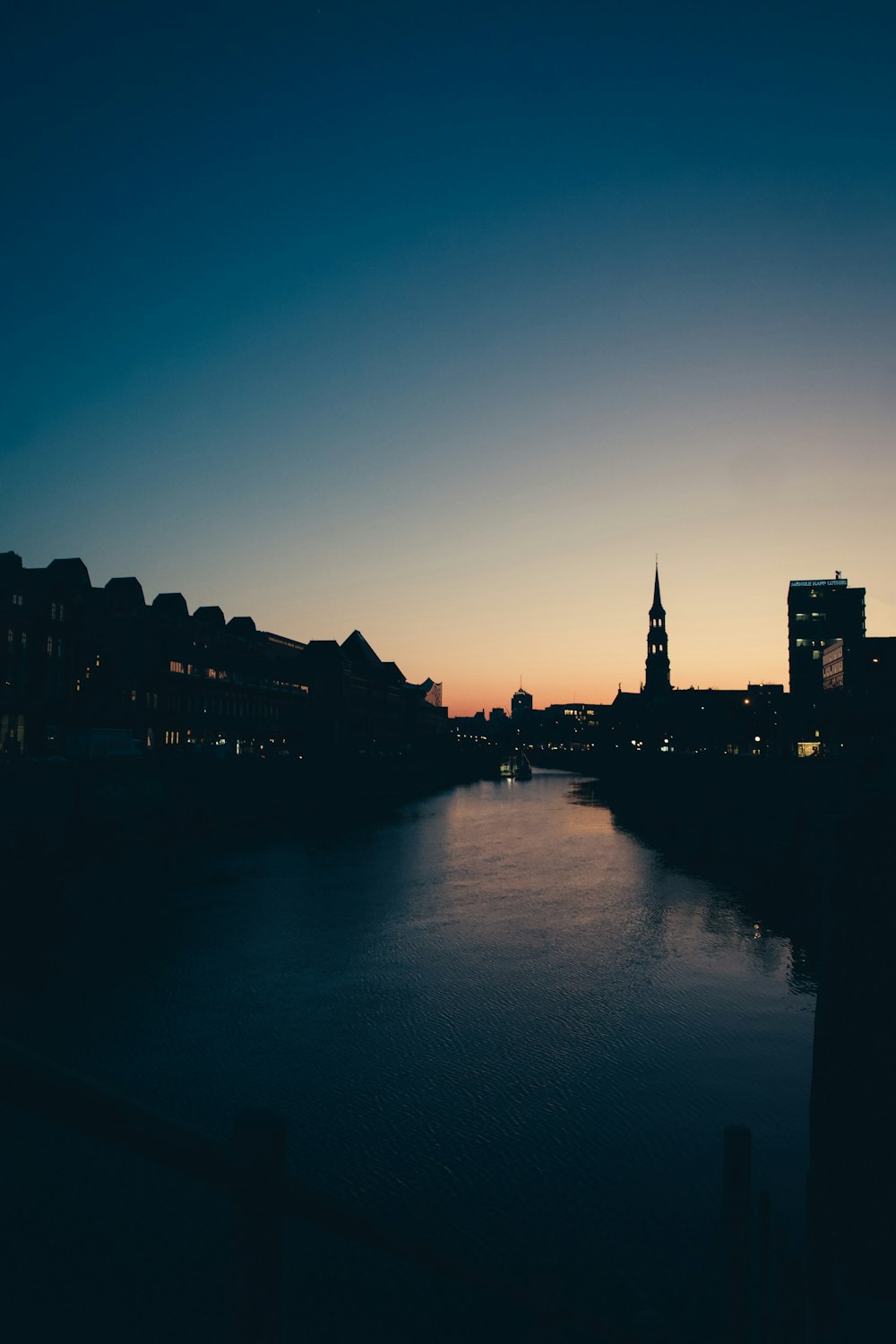 a body of water with buildings in the background