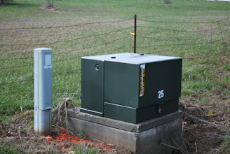 a large green box sitting in the middle of a field
