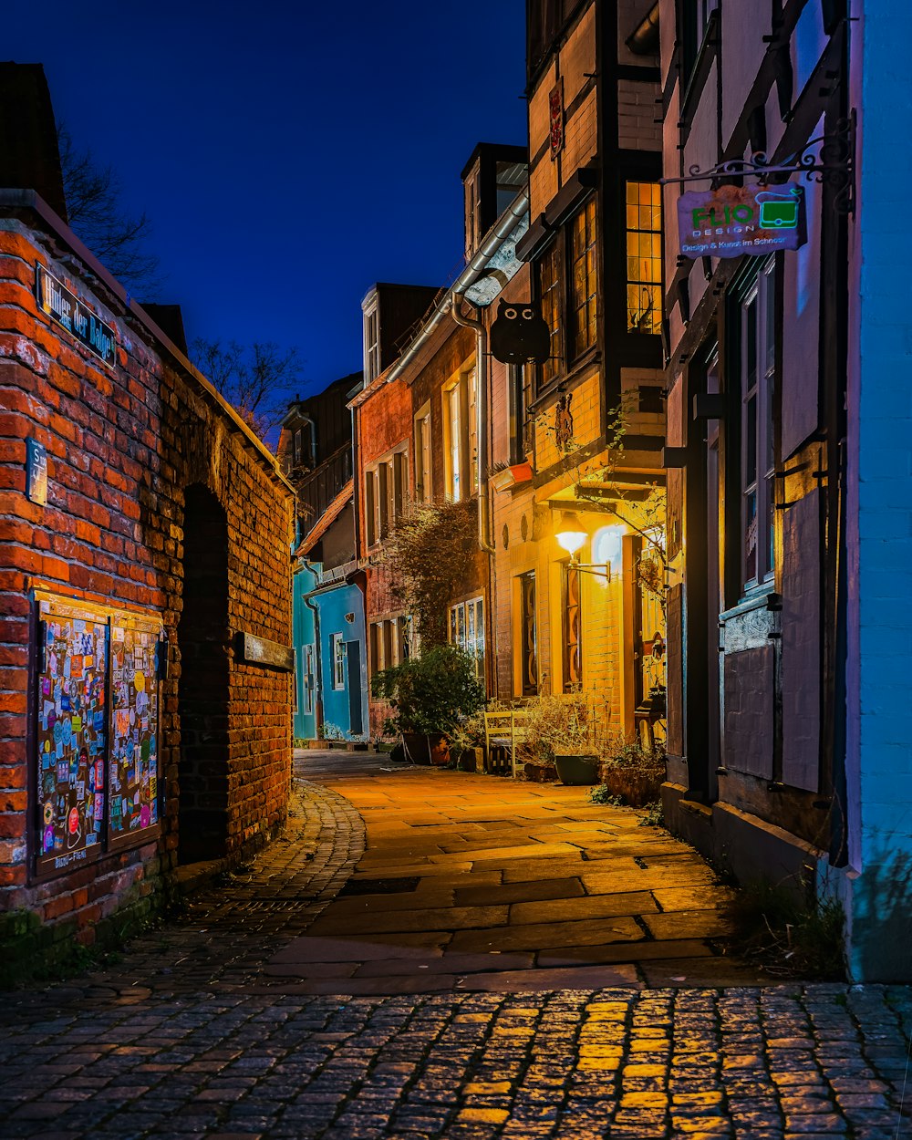 a cobblestone street in a city at night