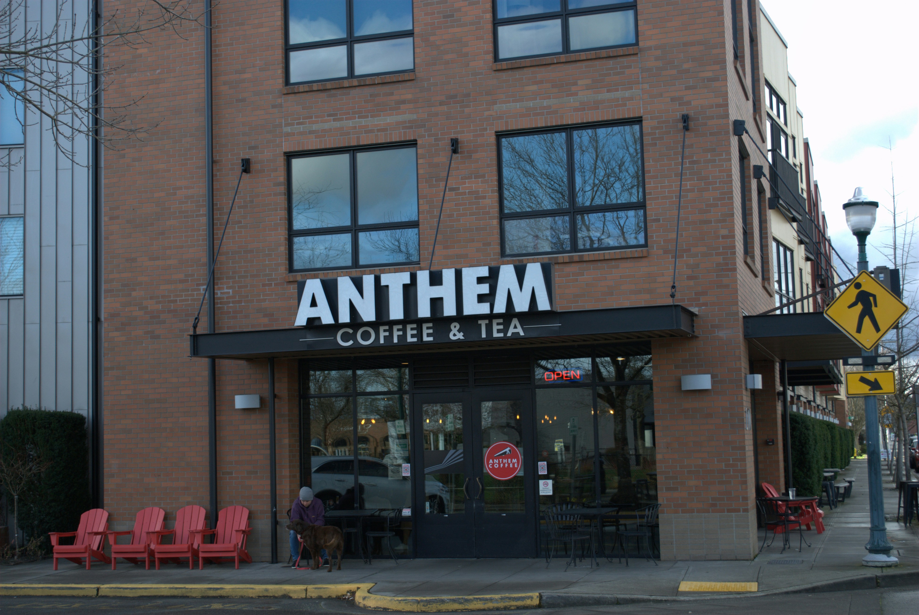 a brick building with a sign that says anthem coffee and tea