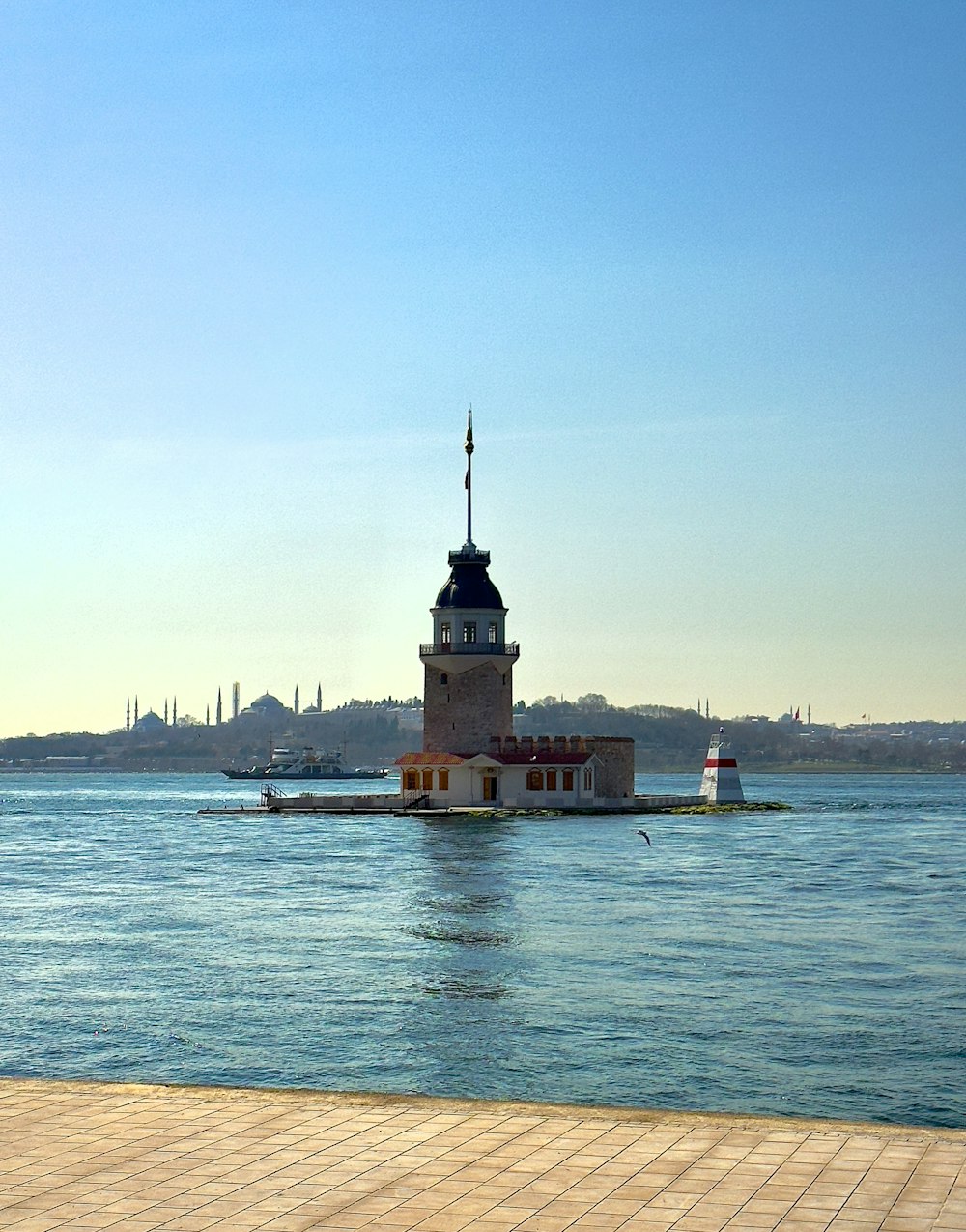 a lighthouse in the middle of a body of water