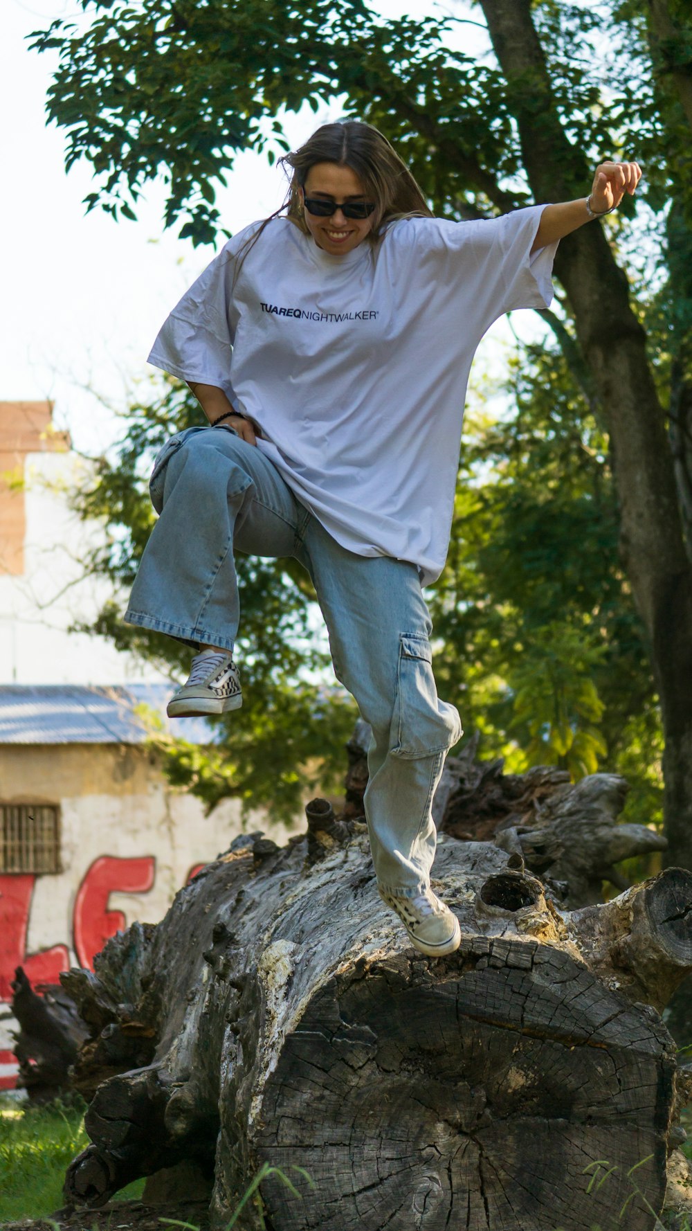 a man riding a skateboard on top of a tree stump