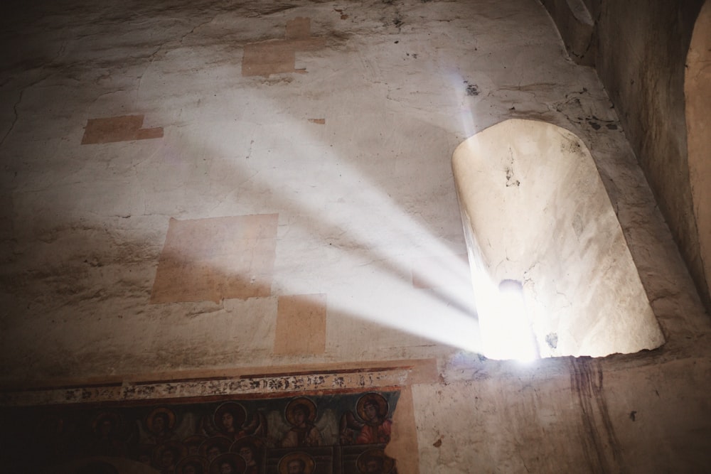 a light shines through a hole in a wall