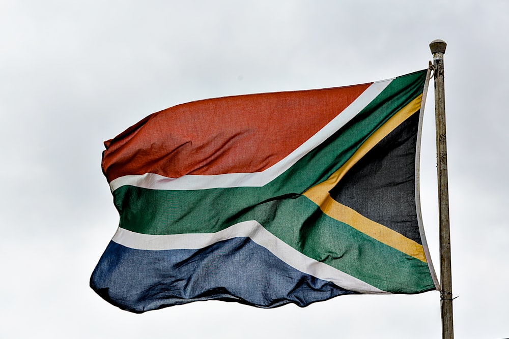 a flag flying in the wind on a cloudy day