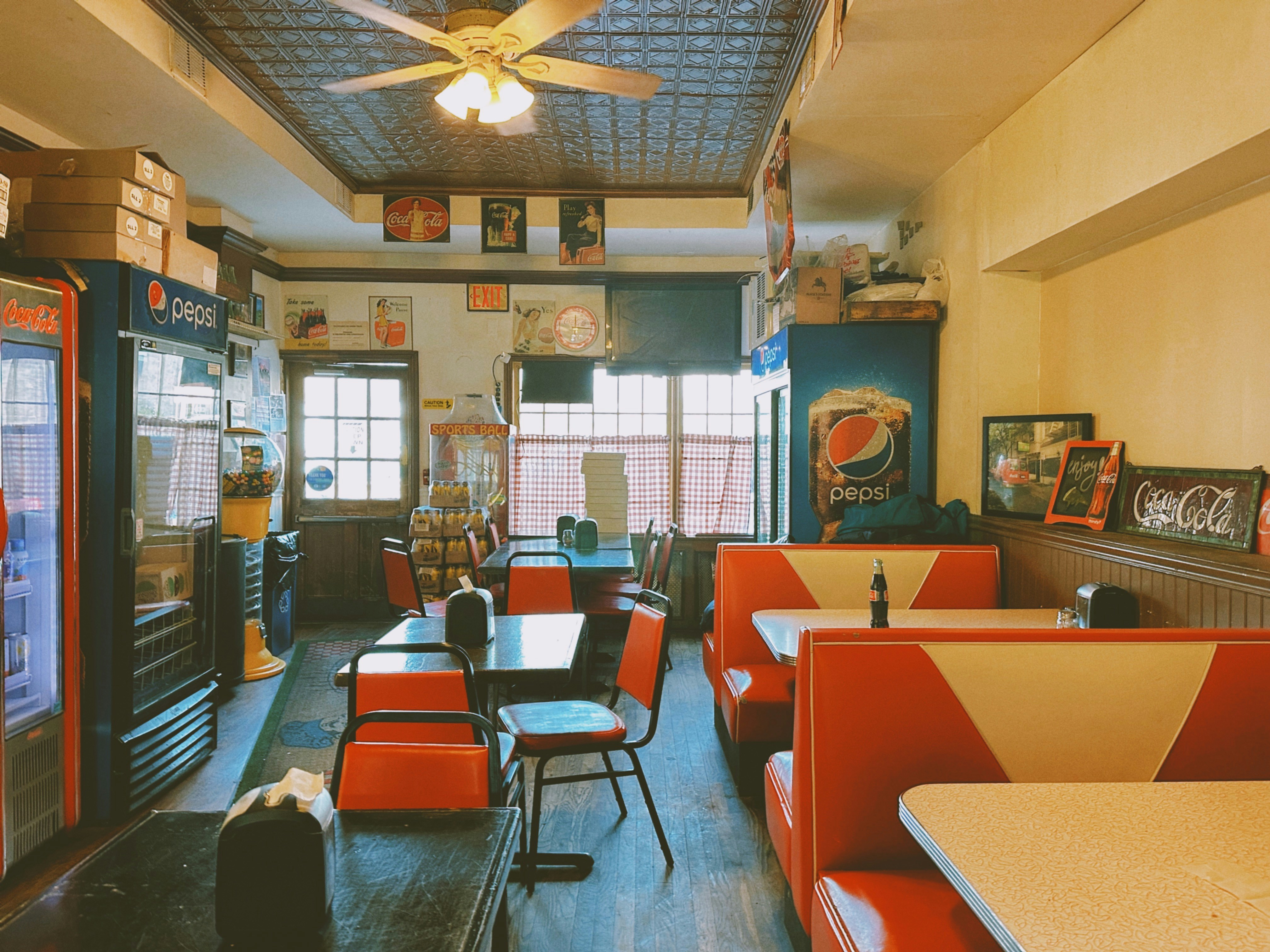 a restaurant with red and white booths and tables