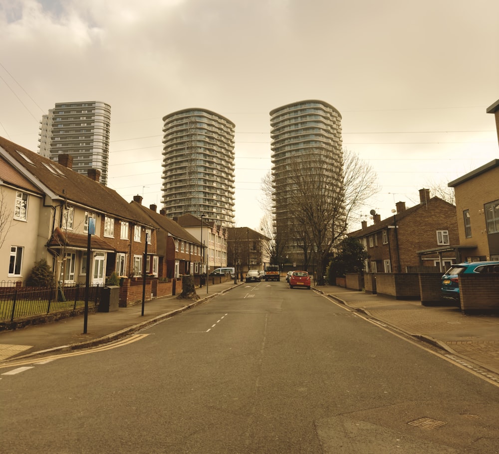 a city street lined with tall buildings and parked cars