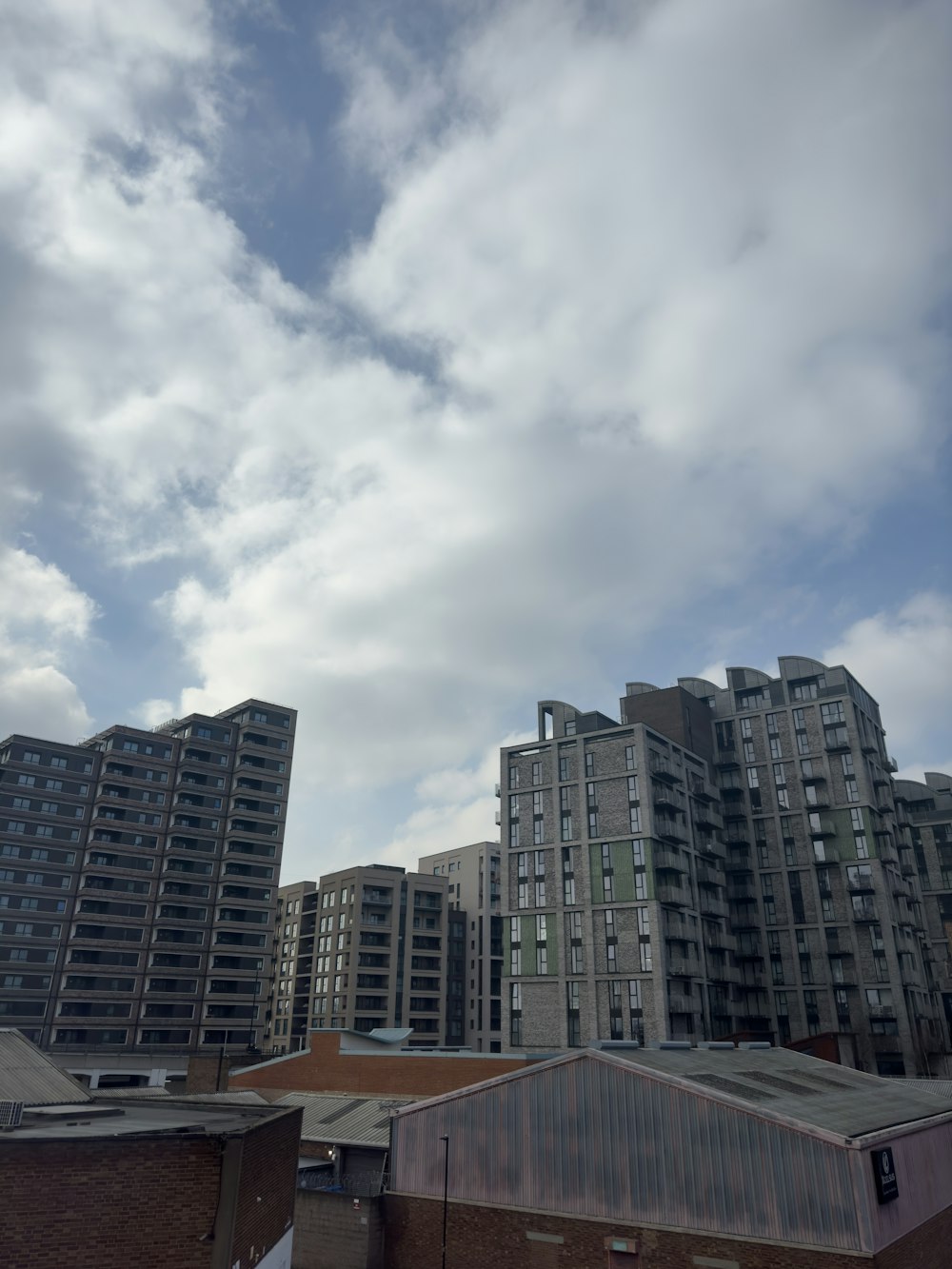 a cloudy sky over a city with tall buildings