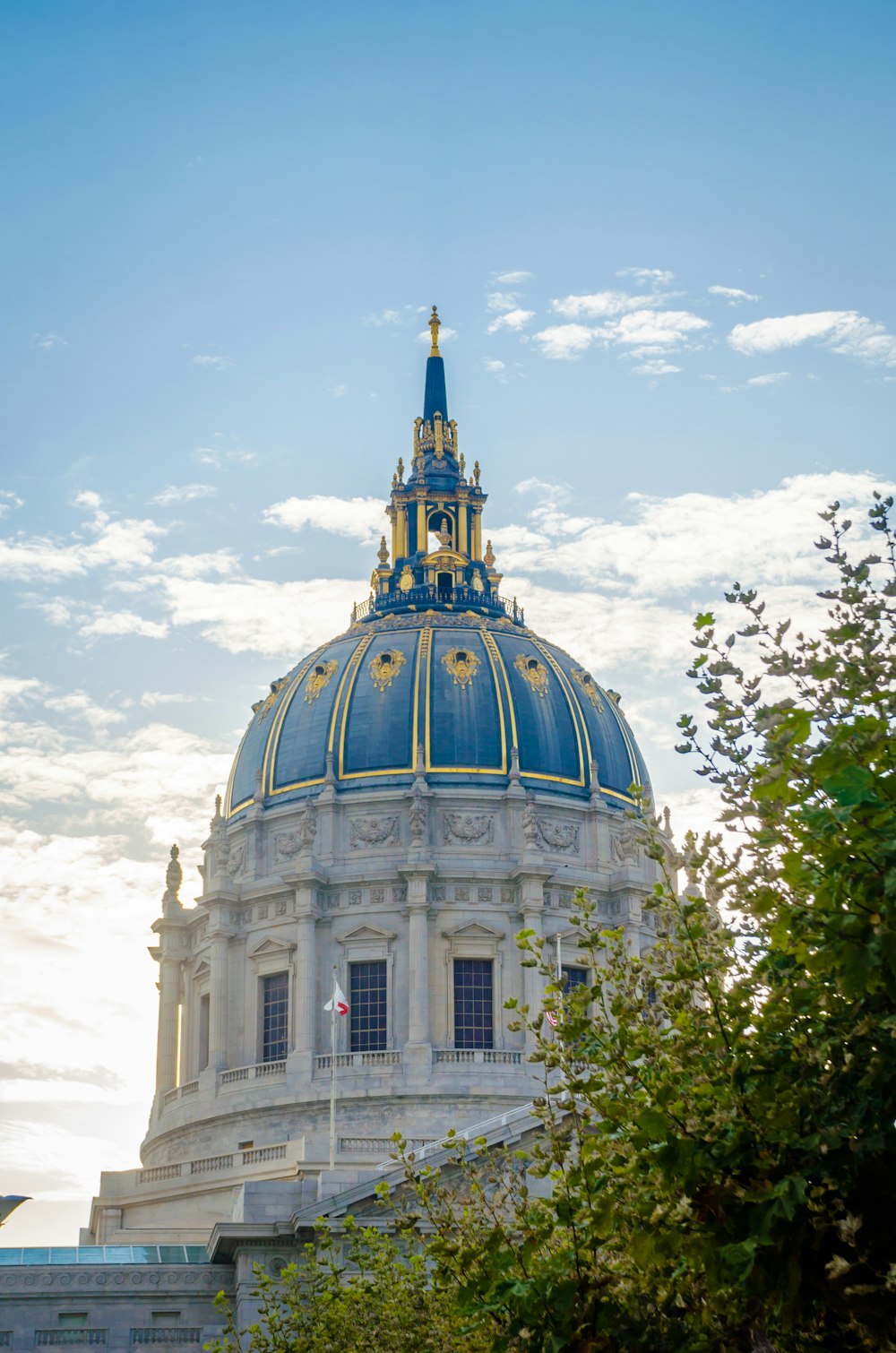 a building with a blue dome and a clock on top