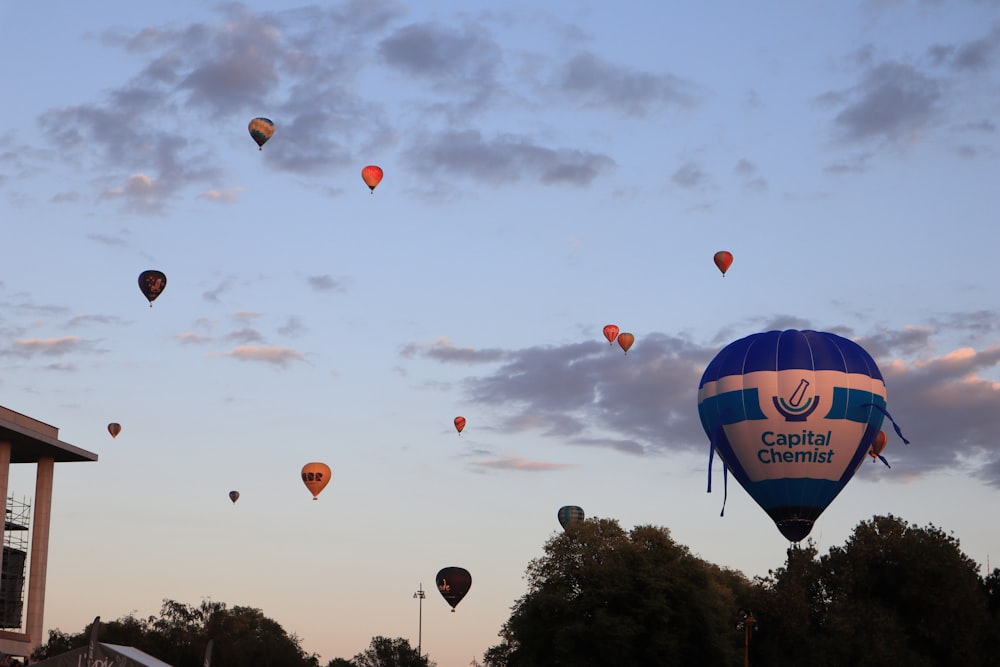 a bunch of hot air balloons flying in the sky