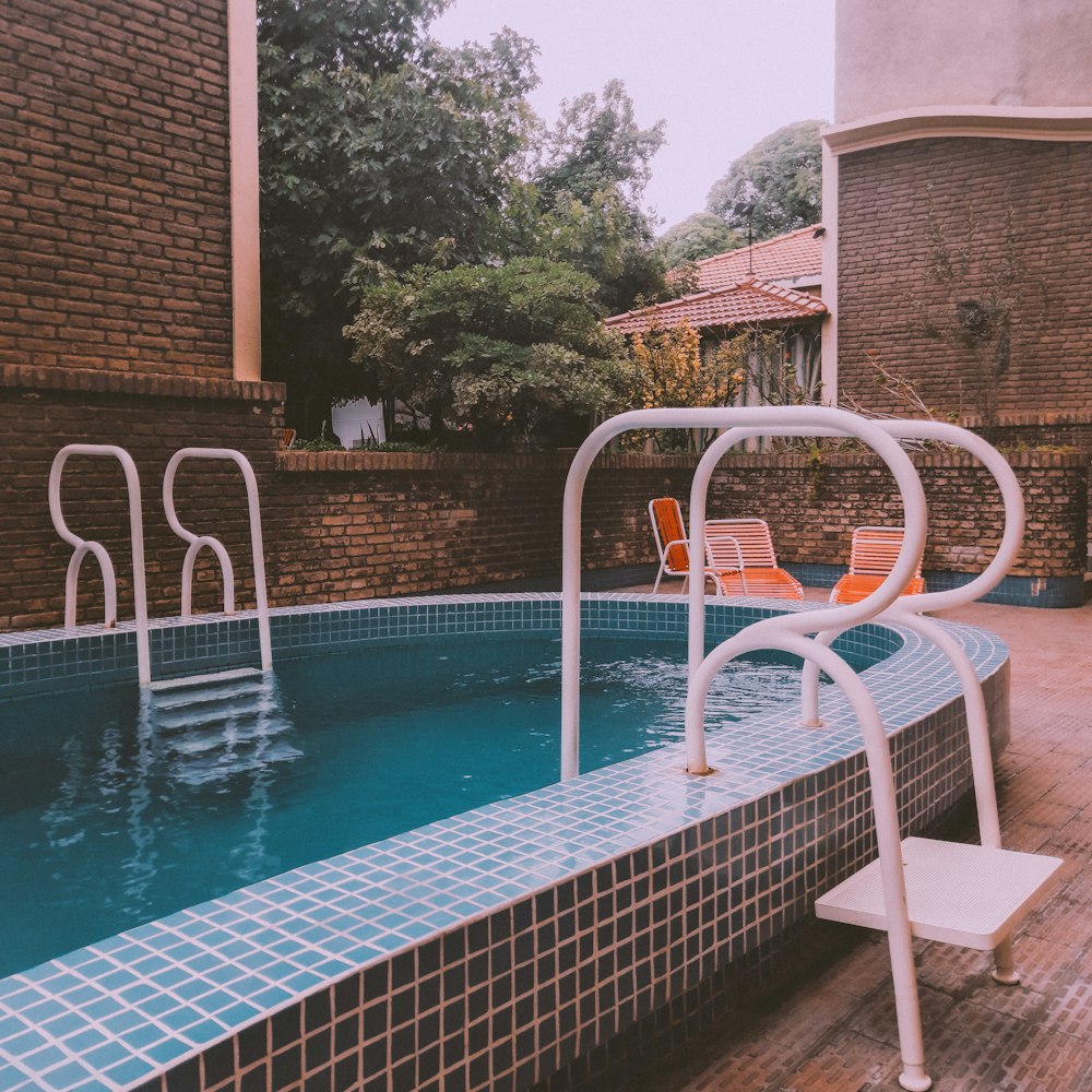 an empty swimming pool with a chair next to it