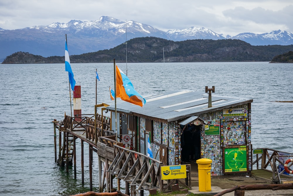 a small shack with flags on the front of it