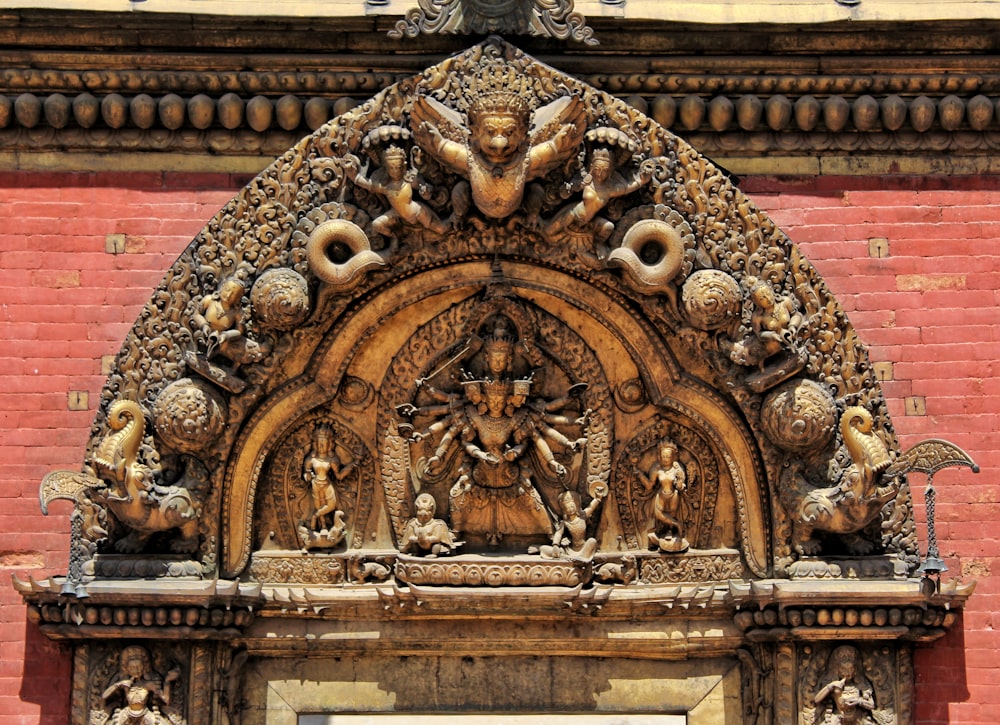 an ornate sculpture on the side of a building