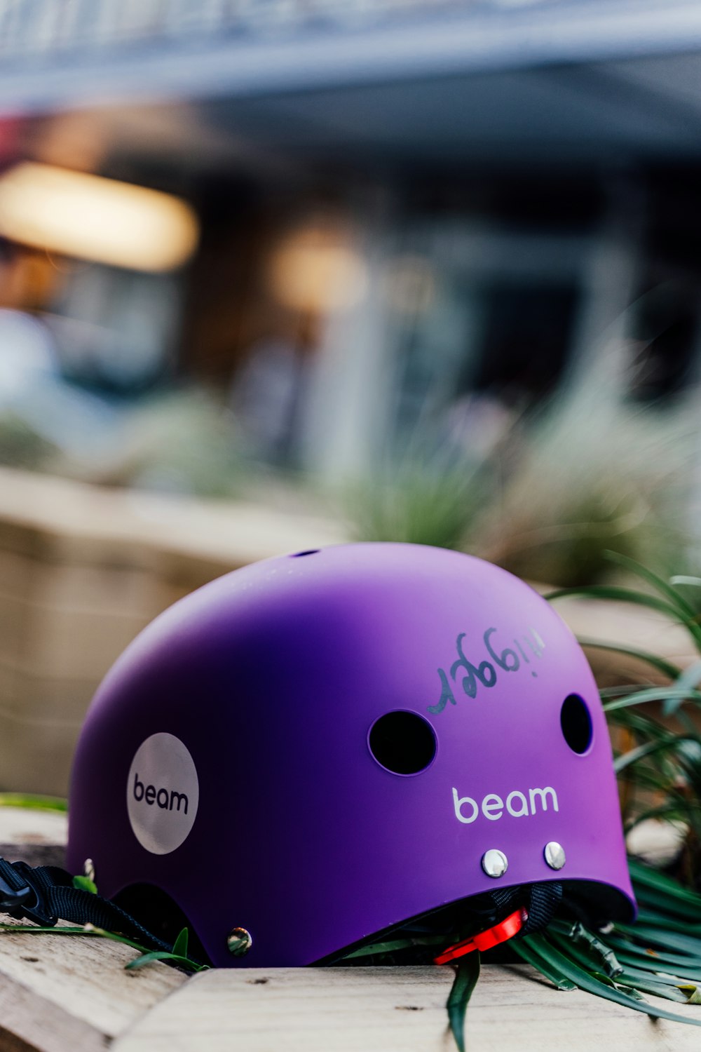 a purple helmet sitting on top of a wooden table