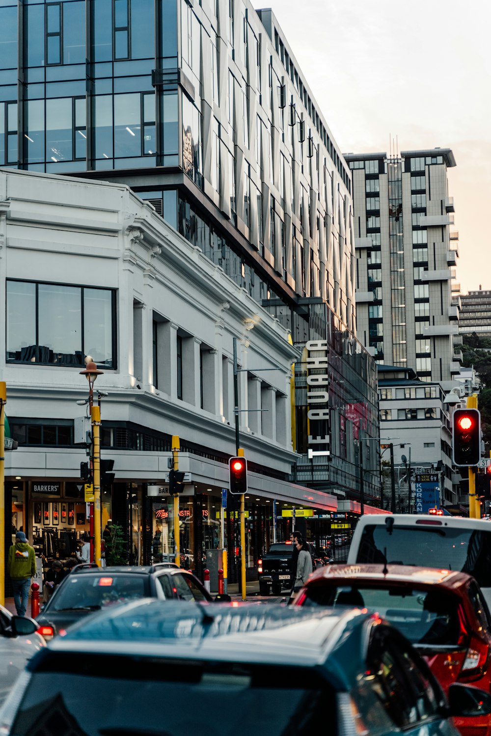 a city street filled with lots of traffic next to tall buildings