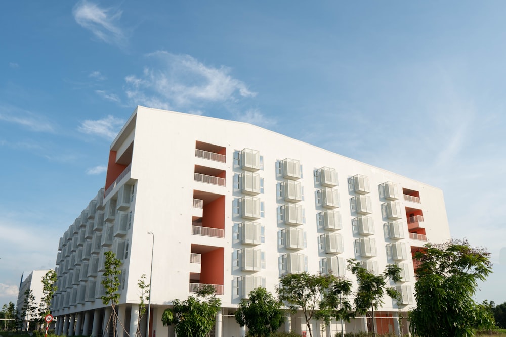 a large white building with red and white windows